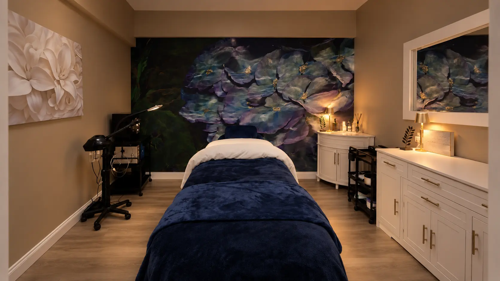 The private Seattle Skin Therapy treatment room, prepared with a navy treatment bed and hydrangea artwork